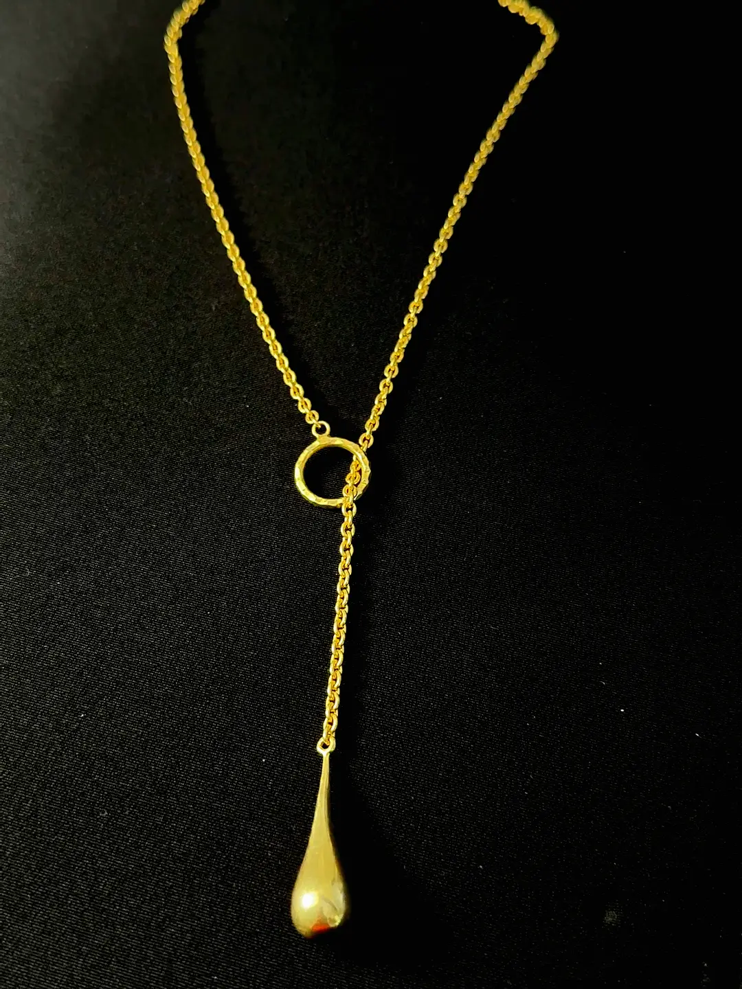Close view of the Amrit hammered ring and the chain pouring through it