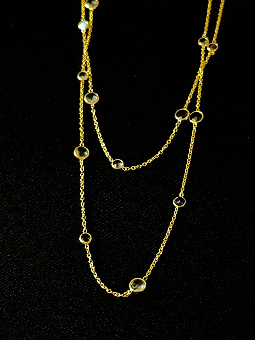 Close view of the bezel-set natural gemstone stations on the Antara chain
