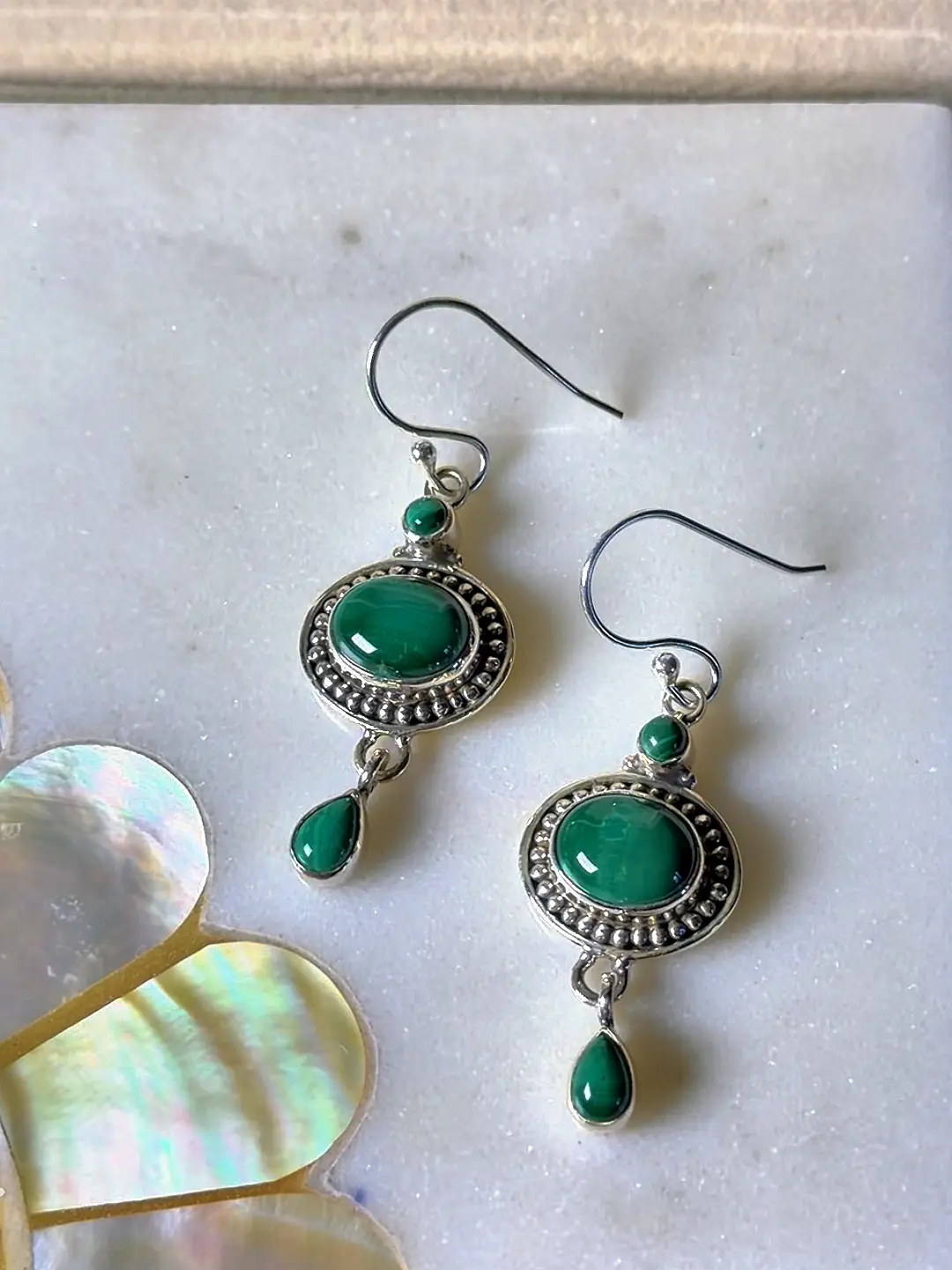 Aranya malachite earrings shown in their Silvorious box