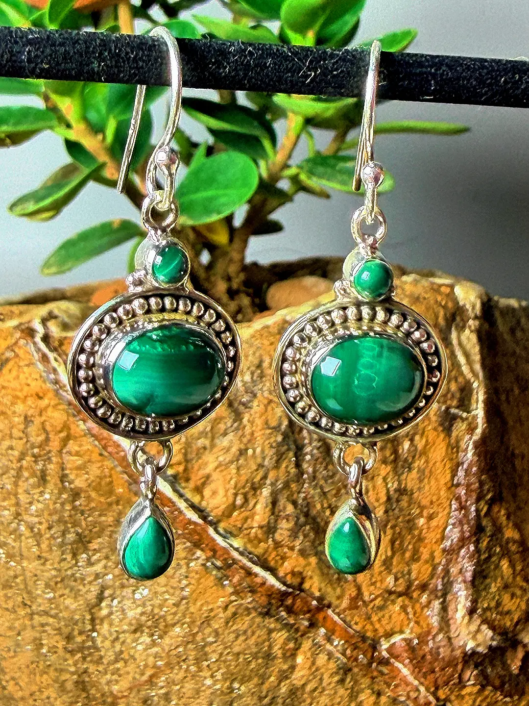 Aranya malachite earrings photographed hanging, showing their drop