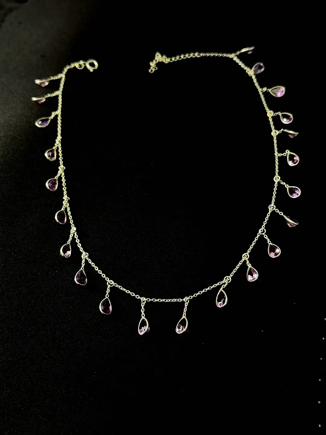 The full Barkha necklace laid out — amethyst pears spaced along a fine sterling silver chain