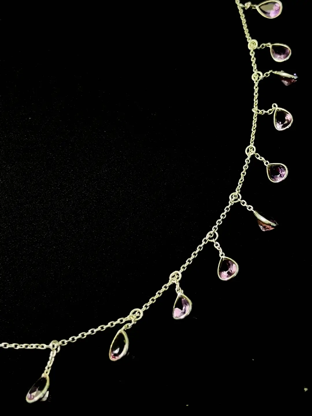 Barkha necklace detail showing the amethyst drops swinging from the chain