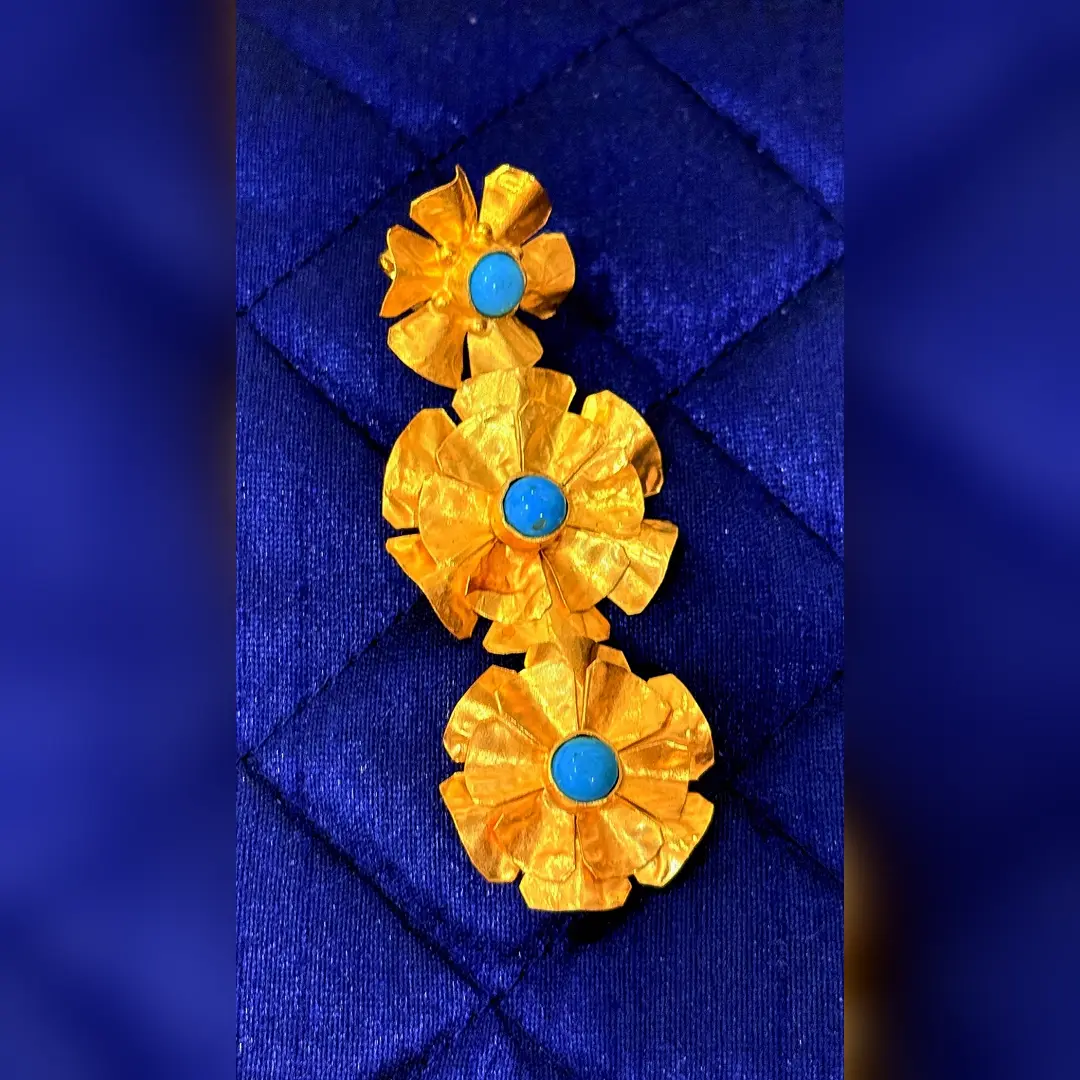 A single Bloom Trio earring, showing the three graduated hammered flowers and turquoise centres
