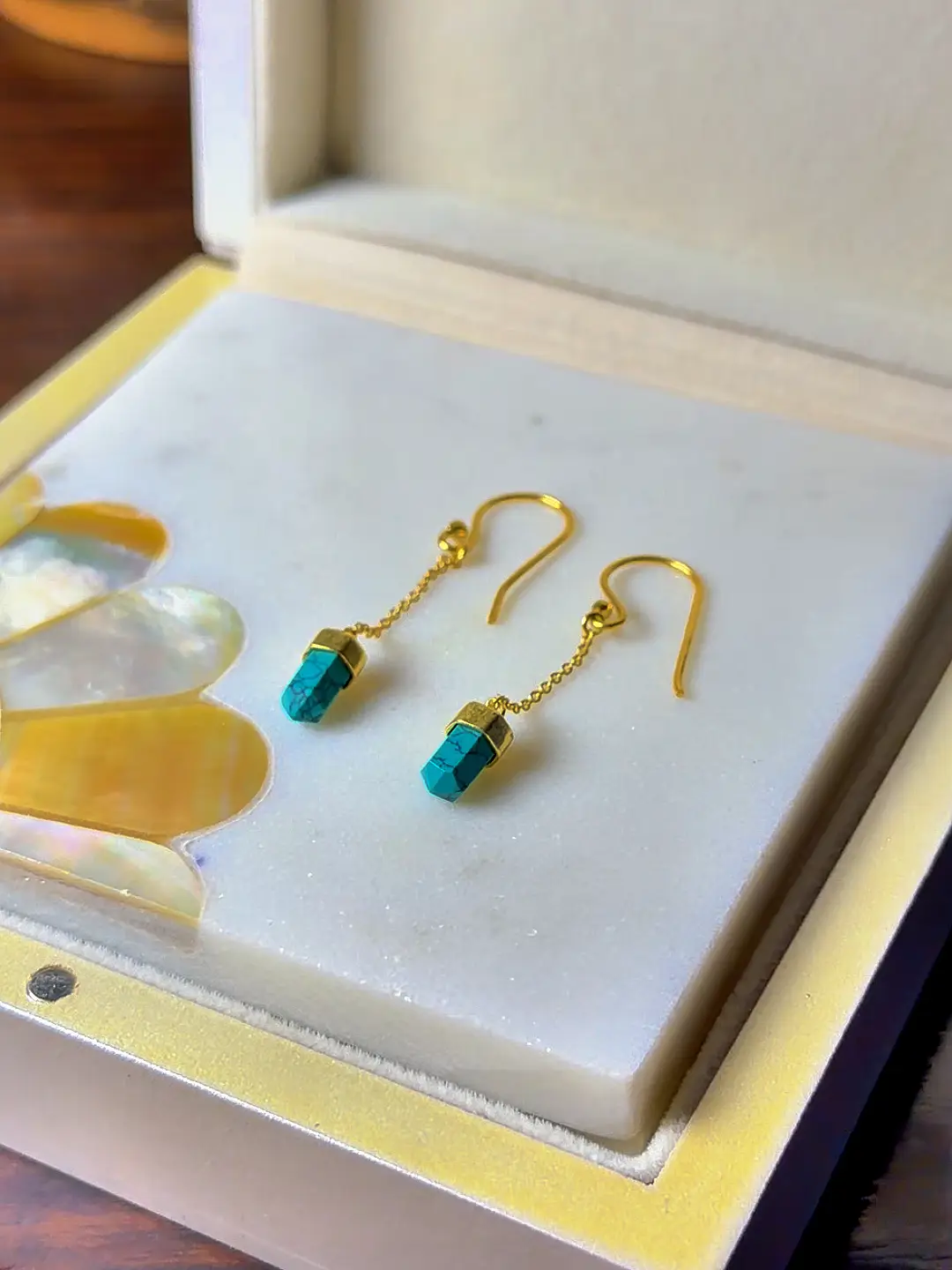 Boond turquoise drop earrings shown in their Silvorious box
