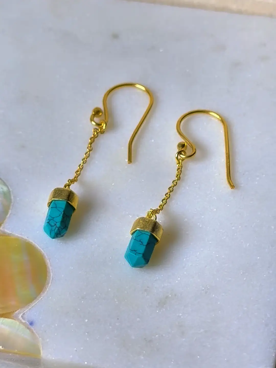 Boond turquoise drop earrings photographed against a neutral ground