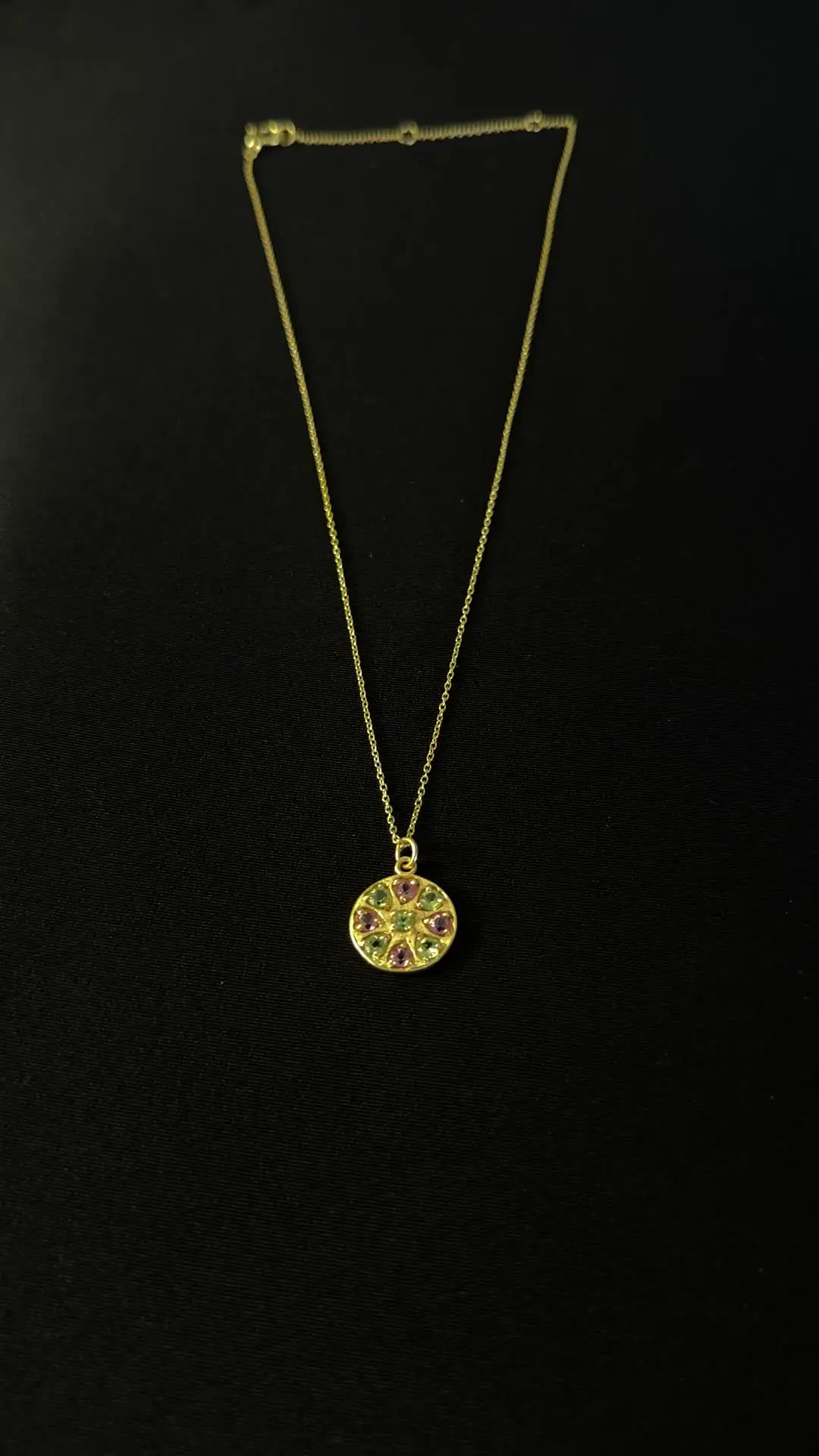 The Chakra disc pendant on its fine gold chain