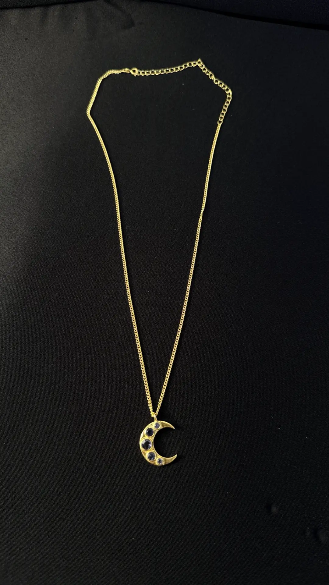 Chandra necklace — a gold crescent moon set with deep blue iolite