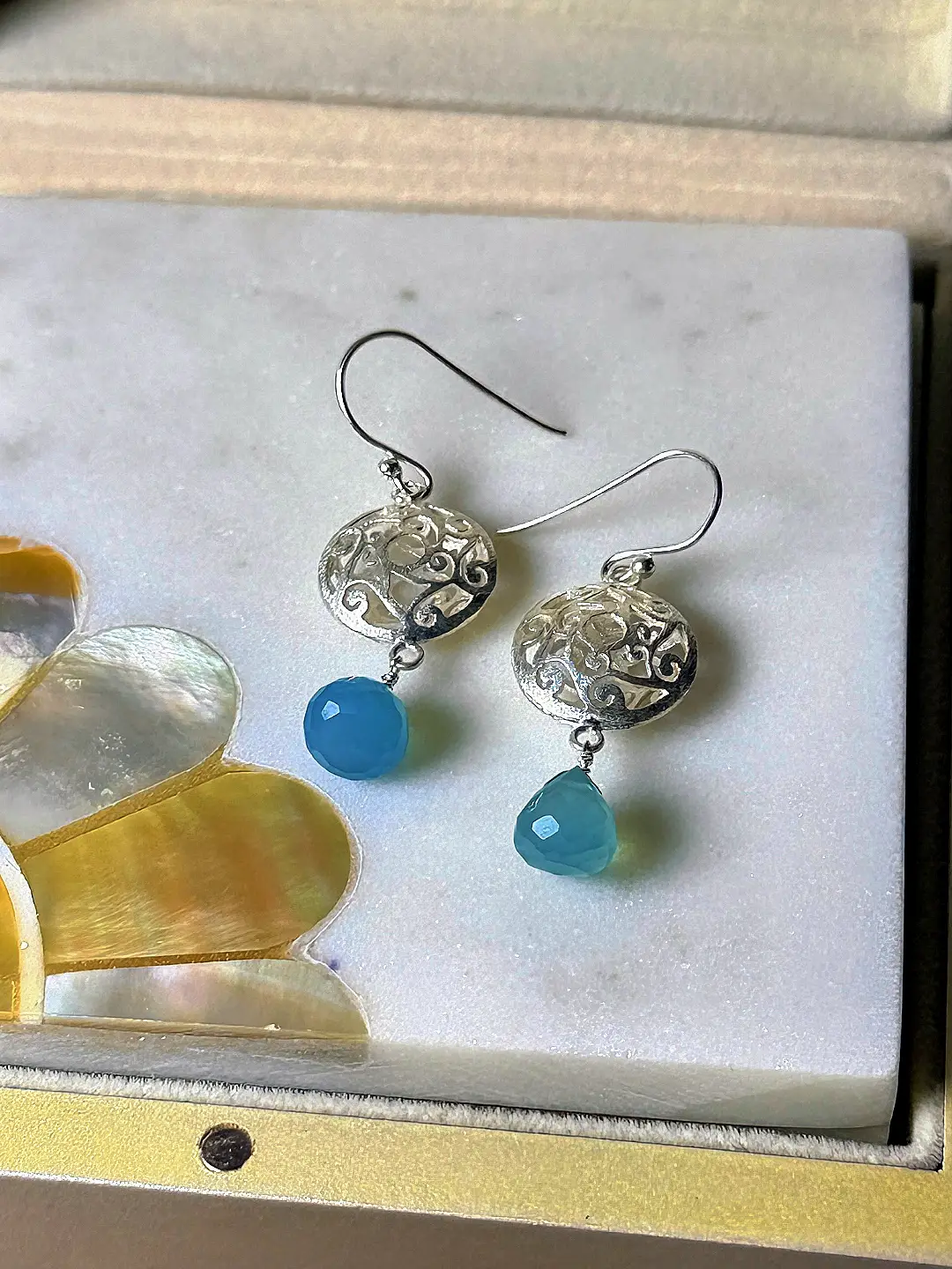 Close view of the pierced vine filigree and the wire-wrapped briolette