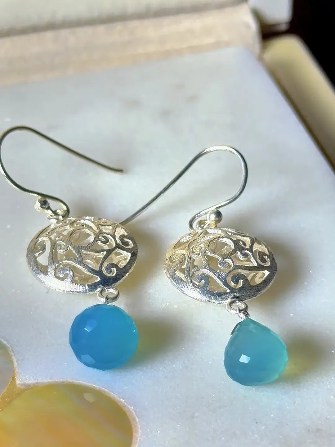 Jheel blue chalcedony drop earrings shown in their Silvorious box