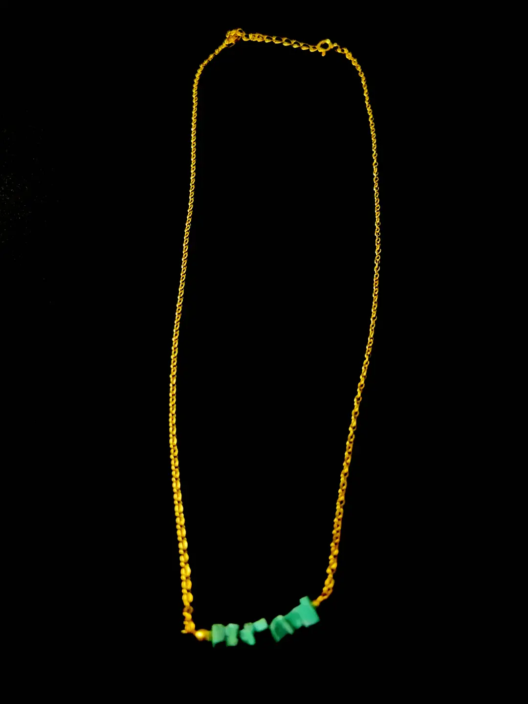 The full 17-inch Kinara chain laid out, turquoise chips at the centre