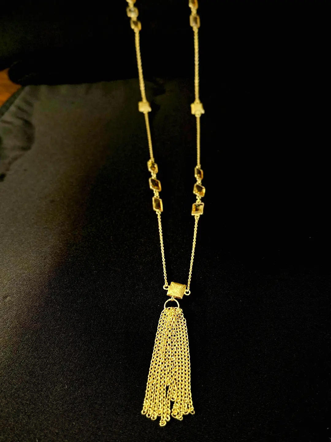 Faceted citrine stations on the Kiran chain above the tassel
