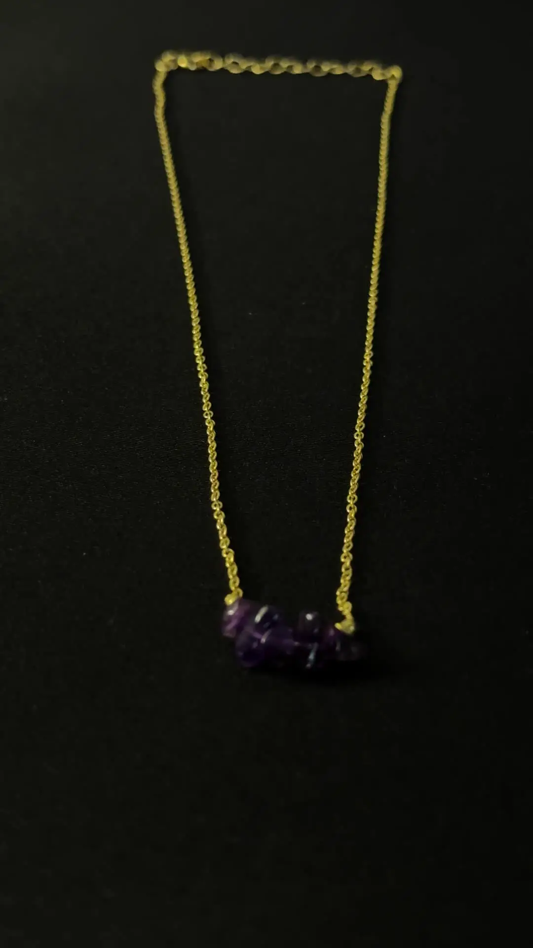 The full Nadi chain laid out, amethyst chips at the centre