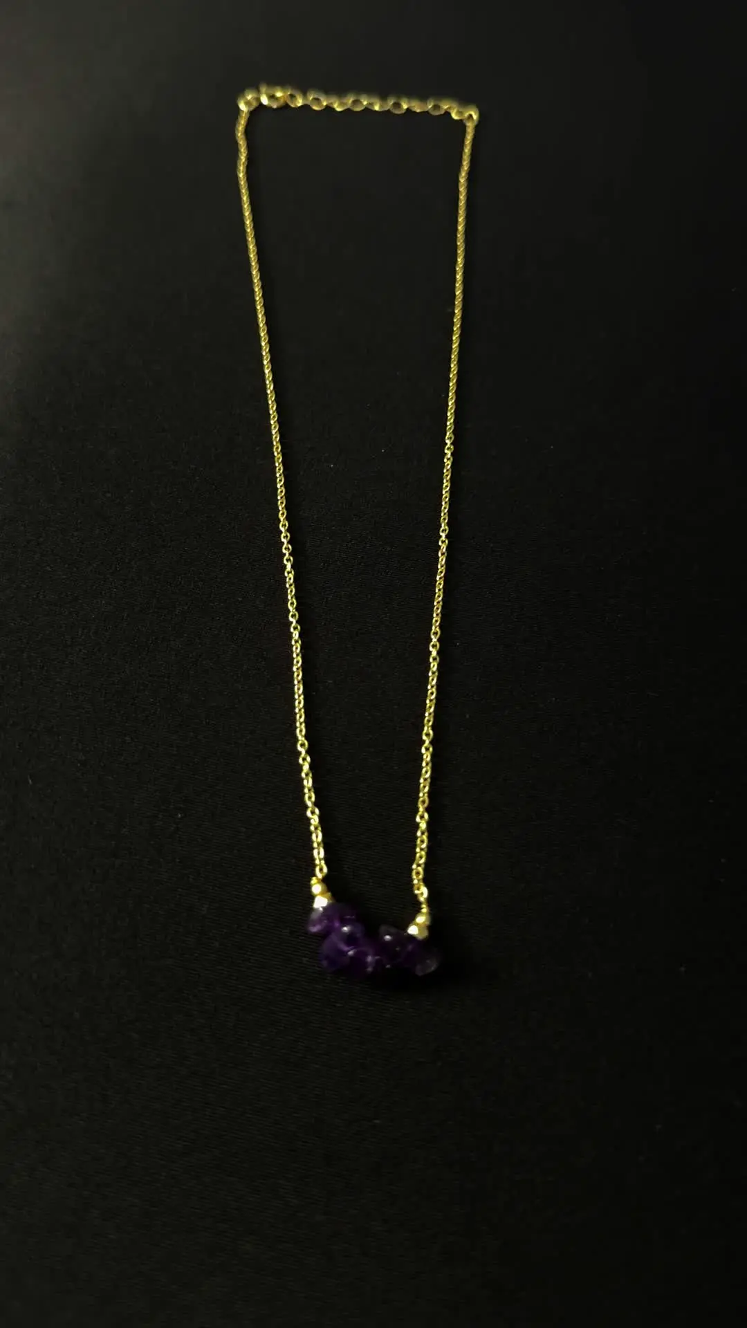 Nadi necklace seen full length on a dark ground