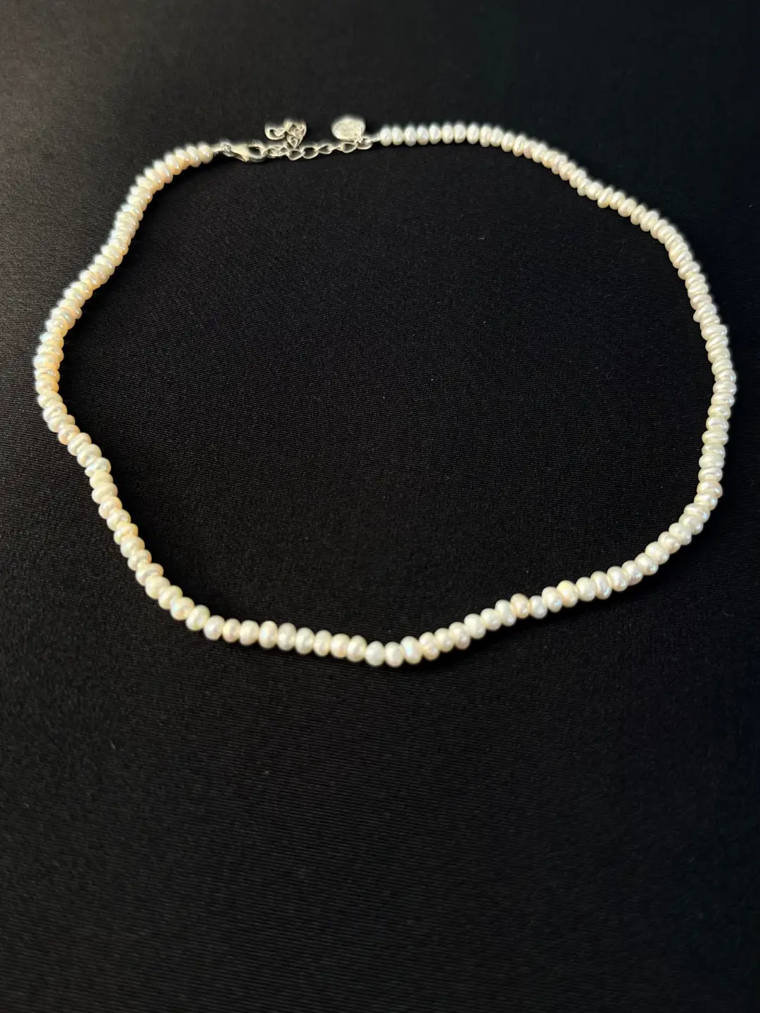 The full Noor choker of small white button pearls