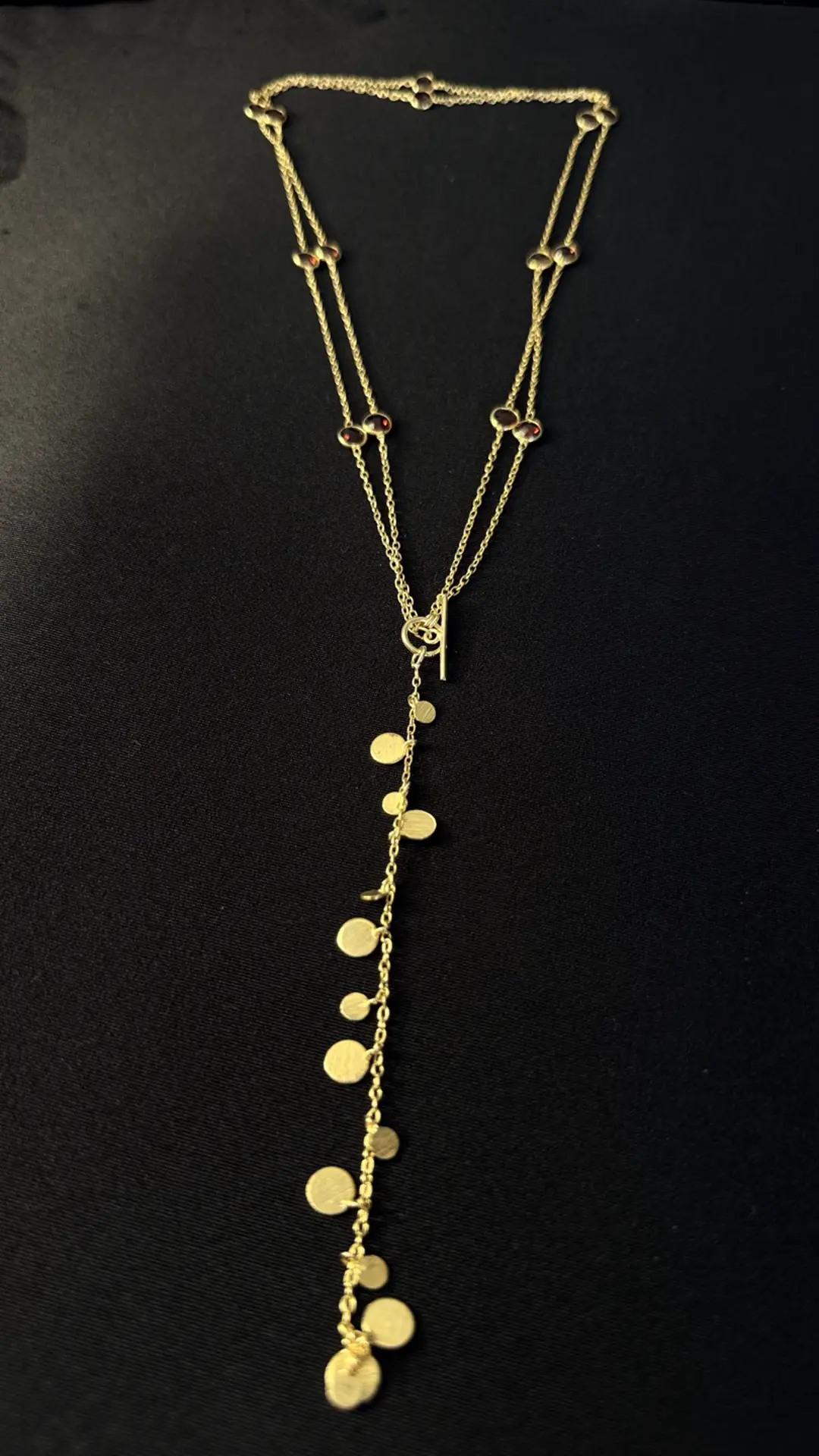 The Payal front toggle with the disc lariat falling through it