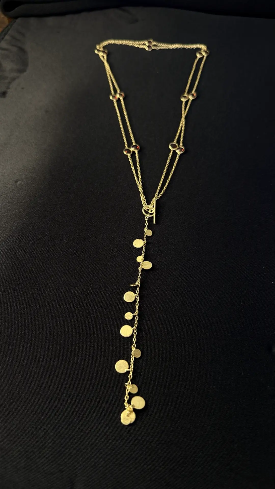 Close view of the Payal garnets and brushed gold discs