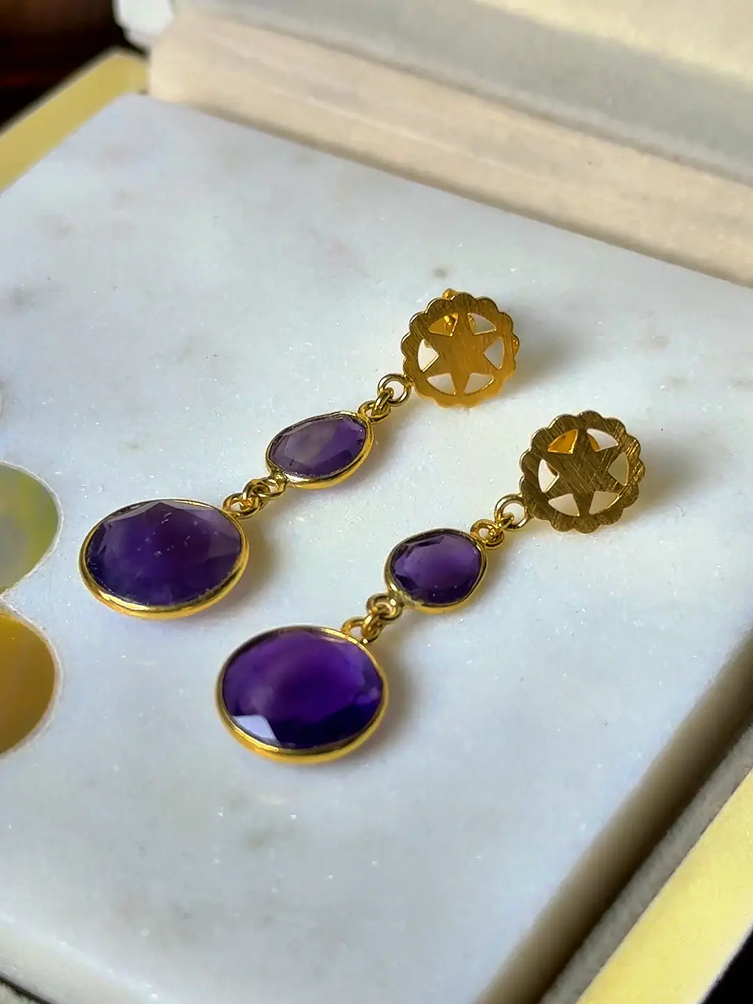 Close view of the Sandhya amethysts and the star-cut rosette stud
