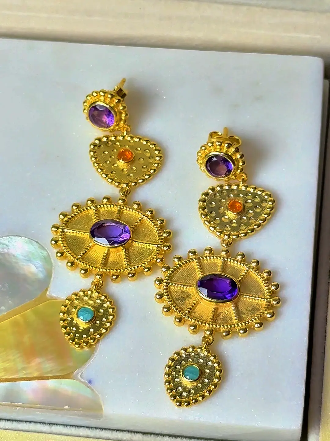Surya temple drop earrings angled to show the granulation and the four tiers