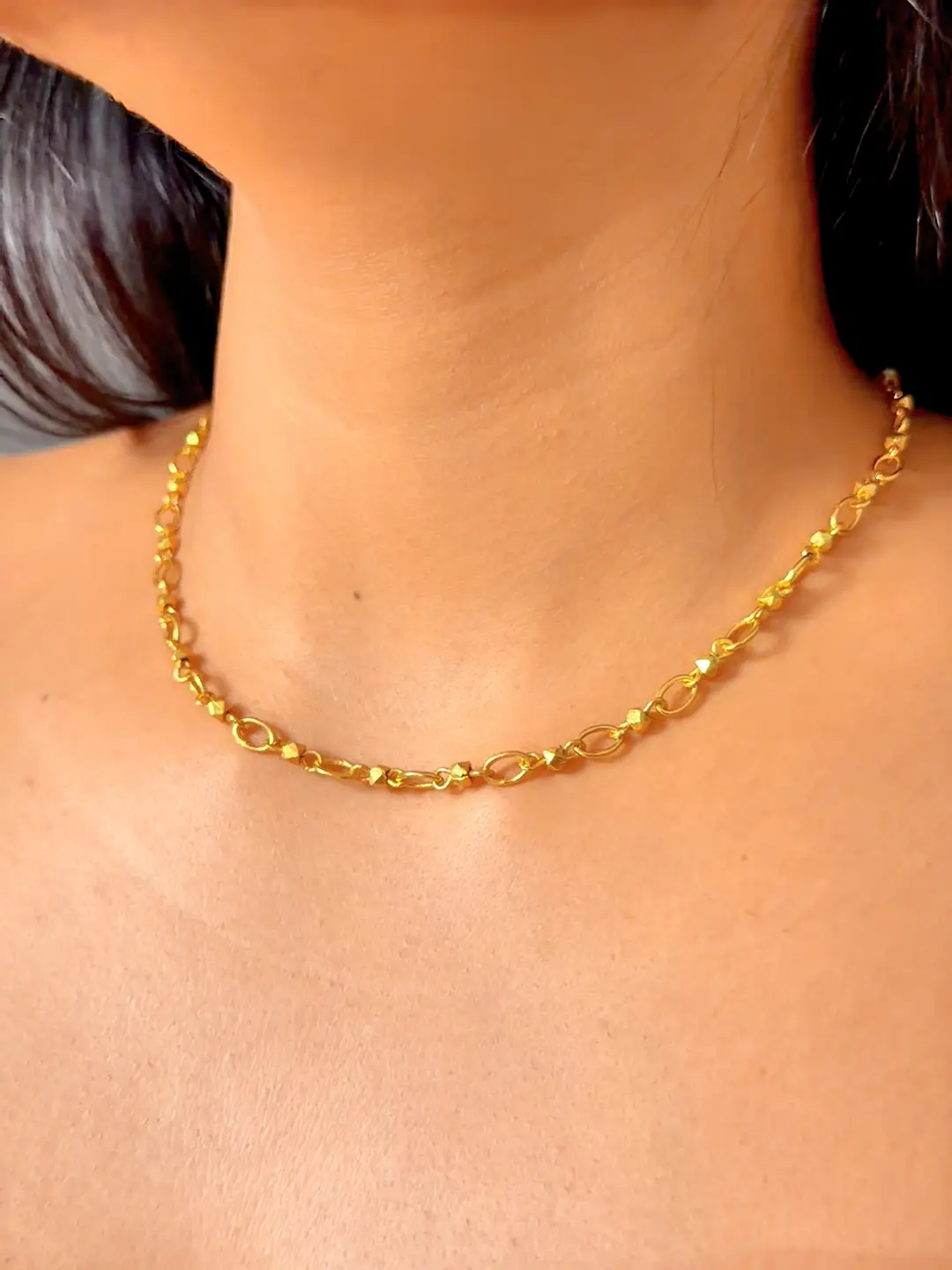 Sutra handmade gold link chain worn at the collarbone