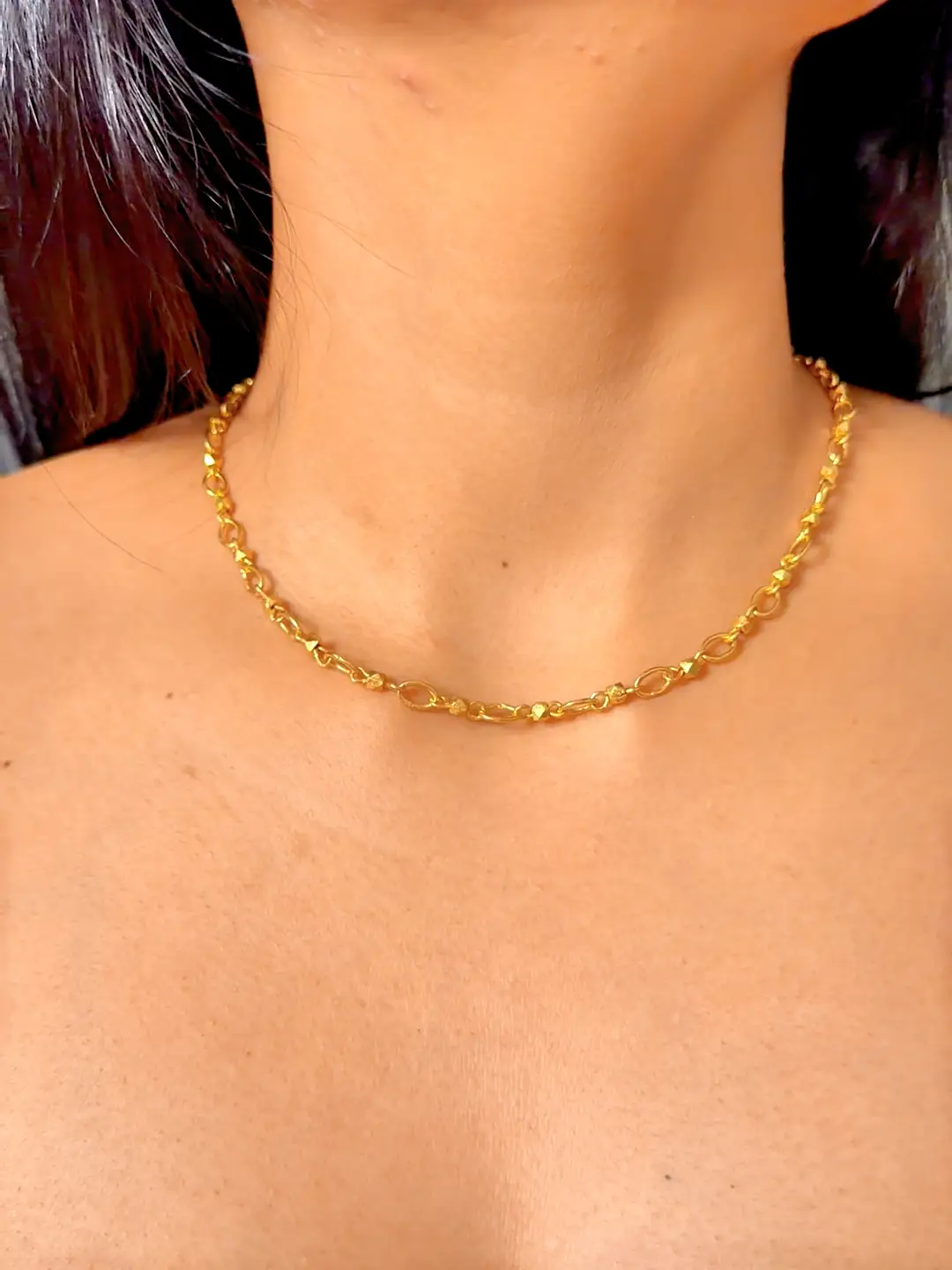 Sutra chain worn, showing the alternating oval links and faceted nuggets
