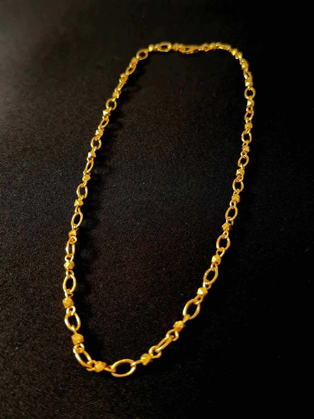 The full Sutra handmade link chain laid out on black
