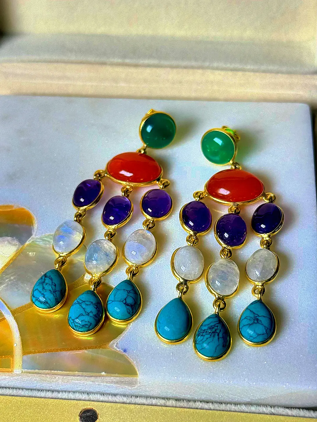 Utsav chandelier earrings angled to show the five bands of gemstone colour